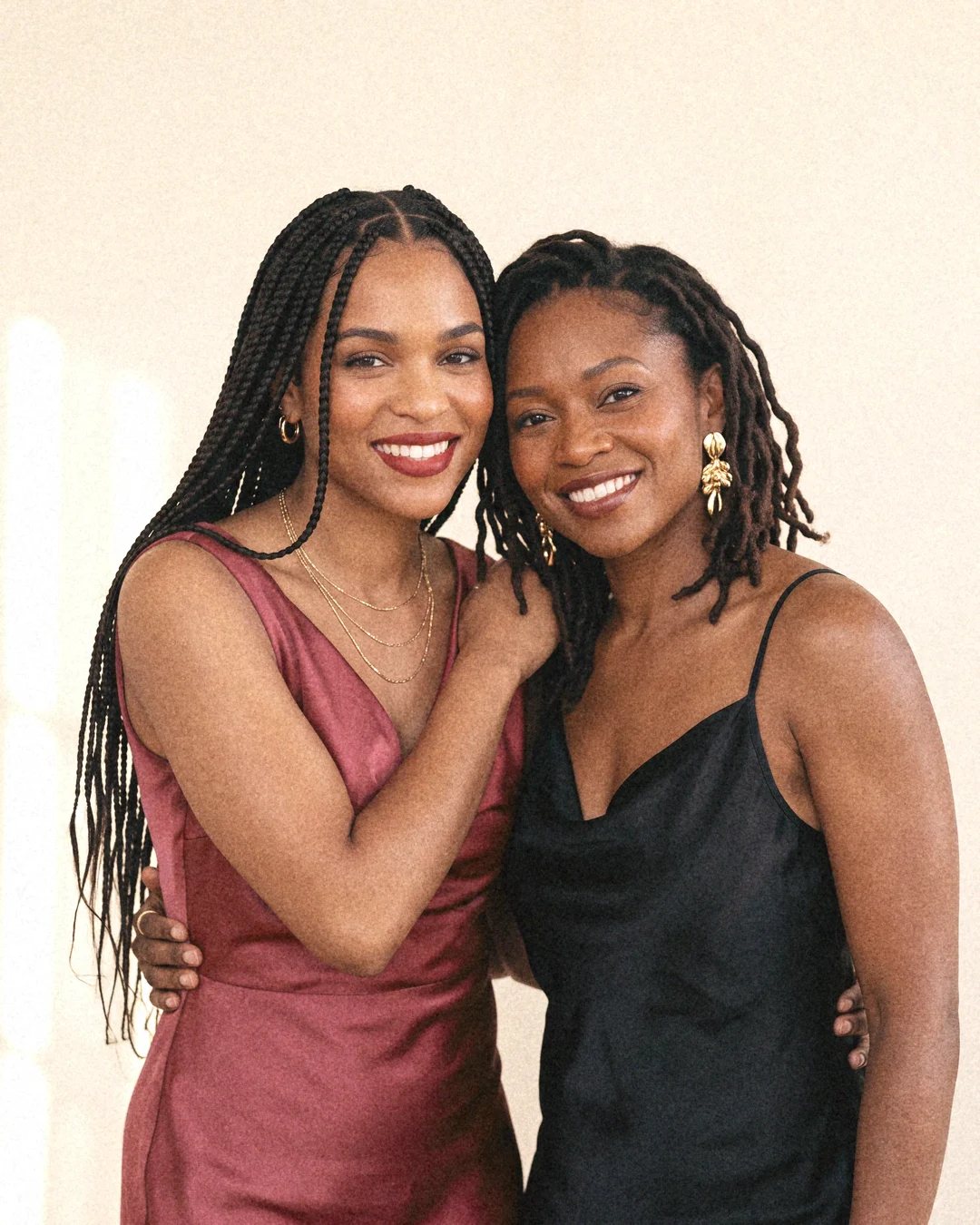 Two women embracing and smiling at the camera.